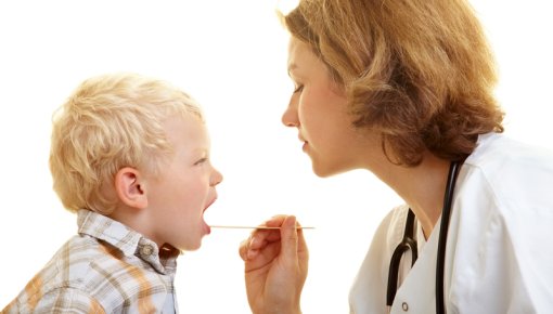Photo of a doctor examining a young child
