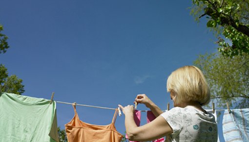 Photo of a woman hanging out laundry