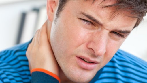 Photo of a man with a painful boil at the back of his neck