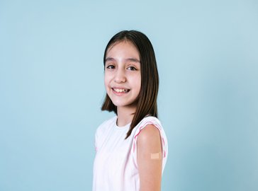 Photo of a girl with a patch on her upper arm