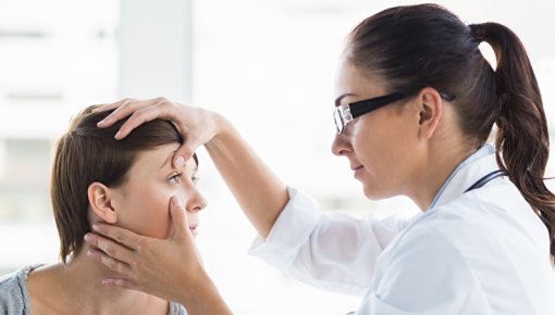 Photo of a doctor examining a woman’s eye
