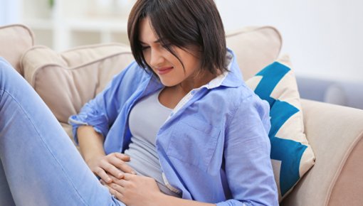 Woman holding her lower belly in pain