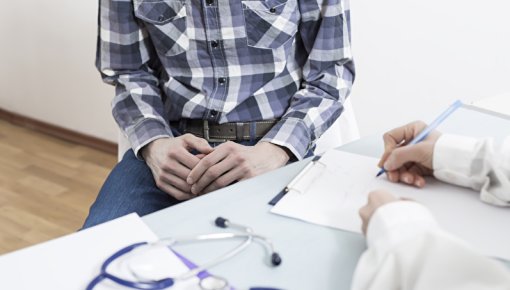 Photo of a man talking to a doctor