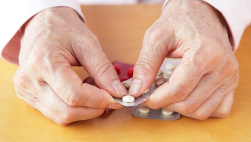 Photo of a person taking tablets