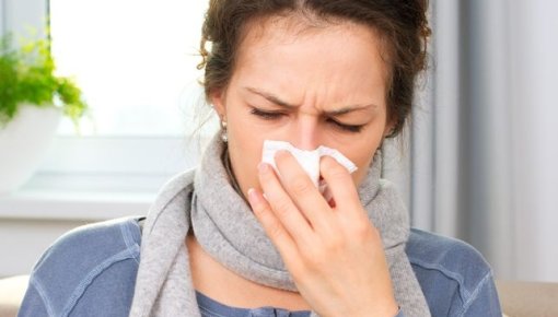 Photo of woman blowing her nose