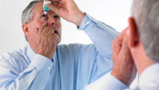 Photo of a man using eye drops