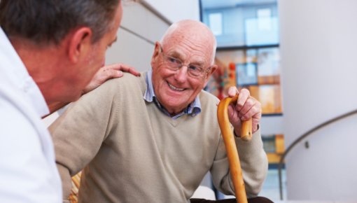 Photo of an older man talking to a doctor