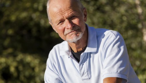 Photo of an older man on a bike