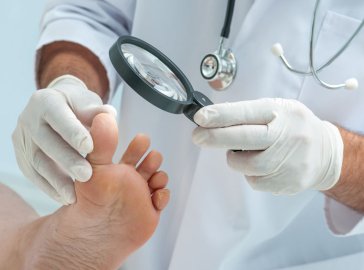 Photo of an older woman and doctor checking for unusual areas of skin