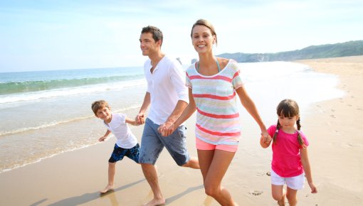 Photo of a family taking a stroll along the beach
