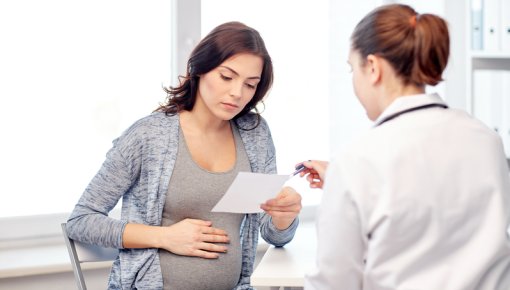 Photo of a pregnant woman and a doctor