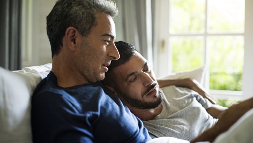 Photo of two men on a sofa