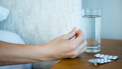 Photo of someone taking tablets