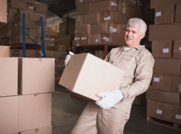 Photo of a worker carrying a heavy package