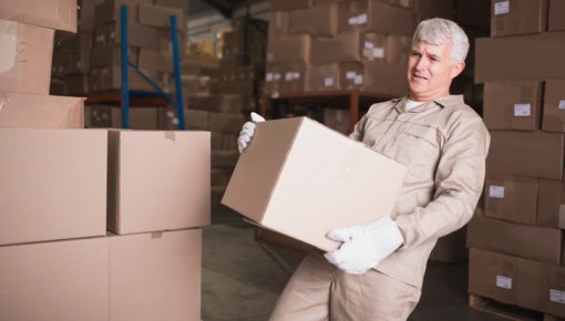 Photo of a worker carrying a heavy package