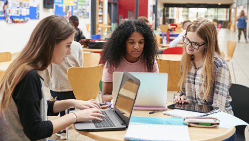 Picture of three female university students using laptops