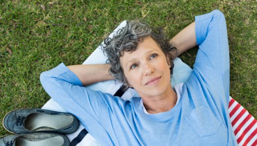 Photo of a woman lying on a picnic blanket