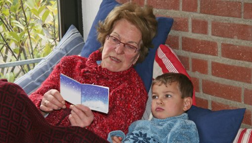 Photo of a grandmother reading to her grandchild