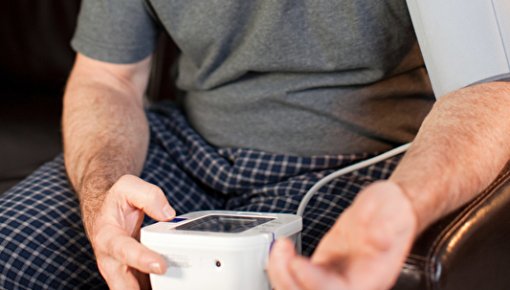 Photo of a man measuring his blood pressure