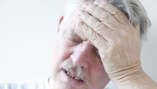 Photo of a man with a bad headache