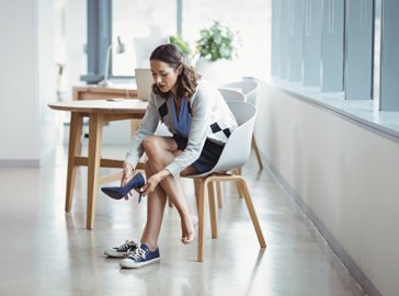 Photo of a woman changing her shoes