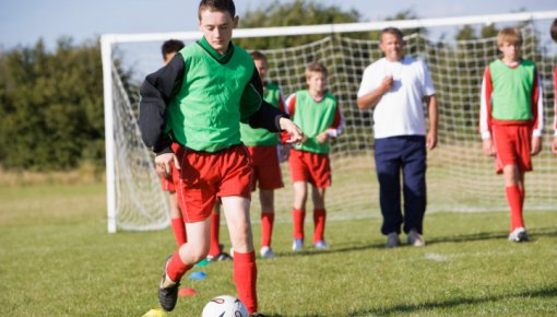 Photo of a group of young men playing soccer