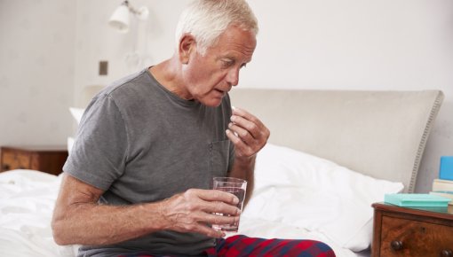 Photo of a man taking painkillers