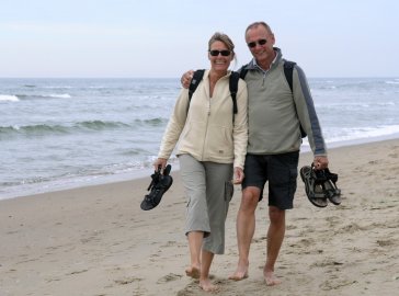 Photo of a couple taking a stroll along the beach