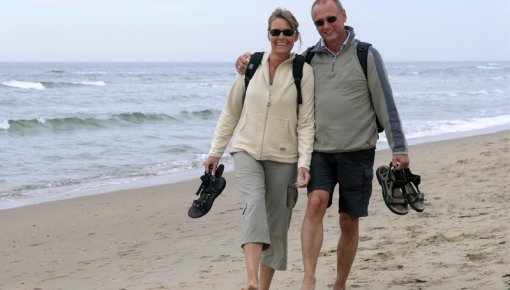 Photo of a couple taking a stroll along the beach