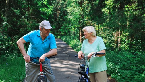 Photo of an elderly couple riding bikes
