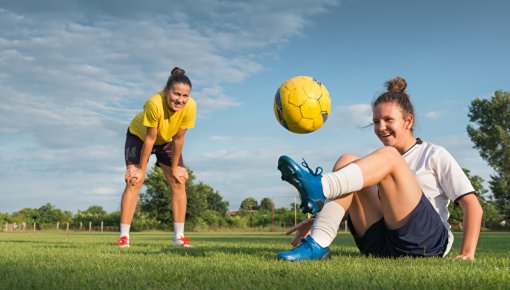 Photo of two women playing soccer