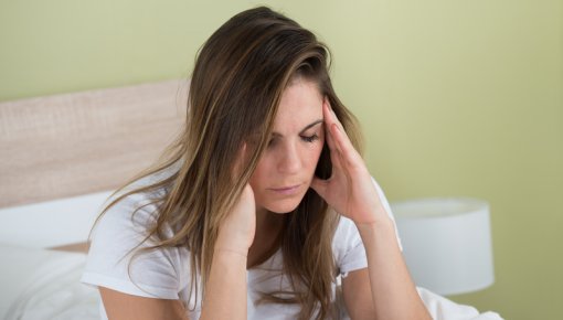 Photo of a young woman with a headache