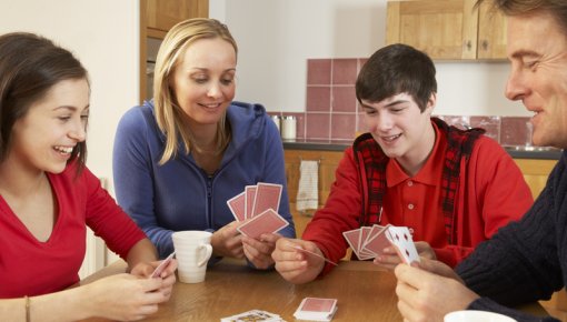 Photo of a family playing cards