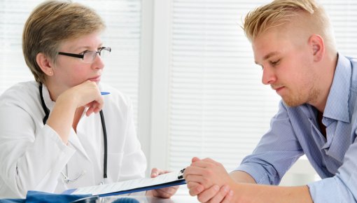 Photo of a young man talking to a doctor