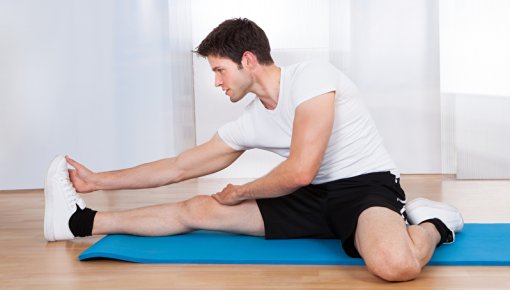 Photo of a man doing stretching exercises