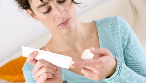 Photo of a woman using an ointment