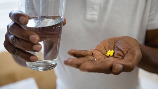 Photo of someone taking tablets