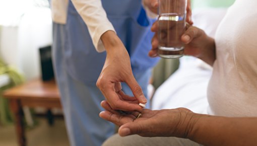 Photo of a person taking tablets