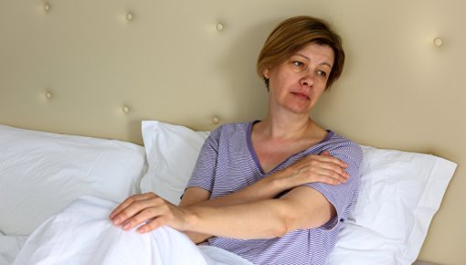 Photo of an exhausted woman in bed