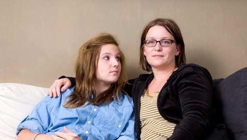 Photo of an exhausted woman with her daughter