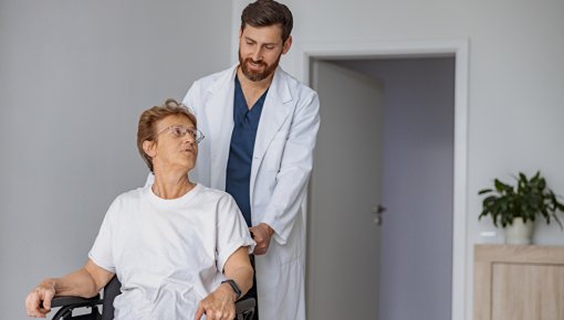 Photo of a woman in a wheelchair with a nurse