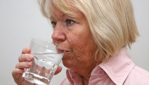 Photo of a woman taking a tablet