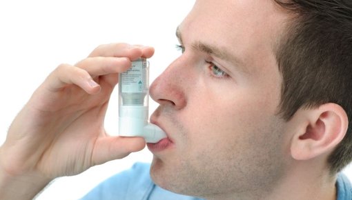 Photo of a man inhaling medicine
