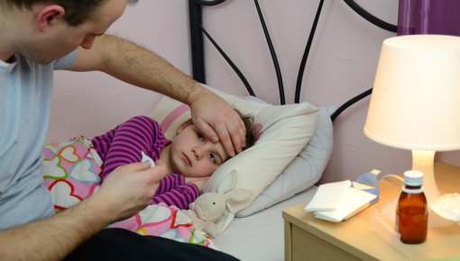 Photo of a man with a child who has a fever