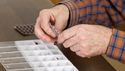 Photo of a patient with a pill box