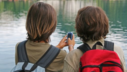 Photo of two boys by a lake