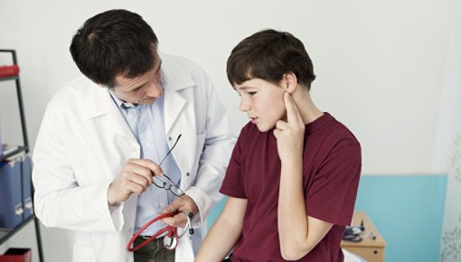 Photo of a boy being examined by a doctor