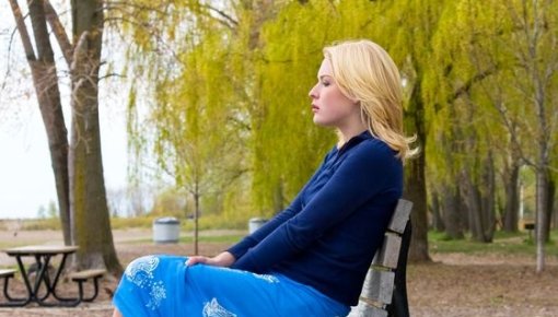 Photo of a woman sitting on a bench