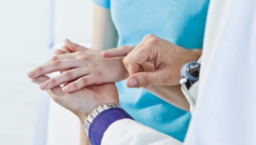 Photo of a young woman being examined by a dermatologist