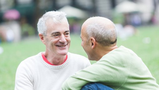 Photo of two men sitting in a park